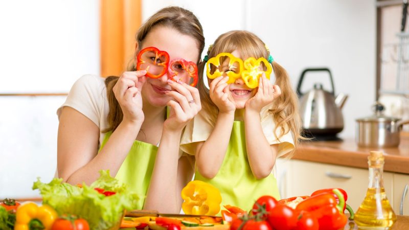 Mom and daughter with pepper slices covering their eyes rsz